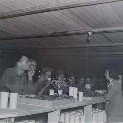 Soldiers eating doughnuts and coffee