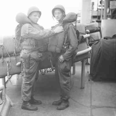 Soldiers checking each other's life vests