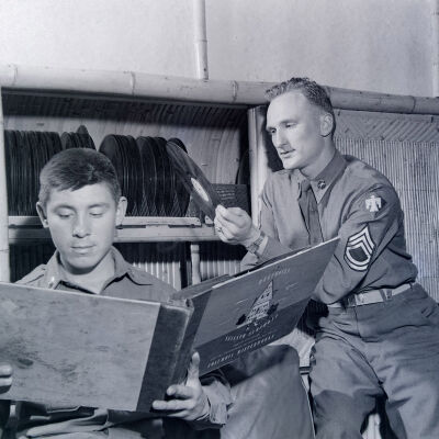 Soldiers looking at records in the barracks
