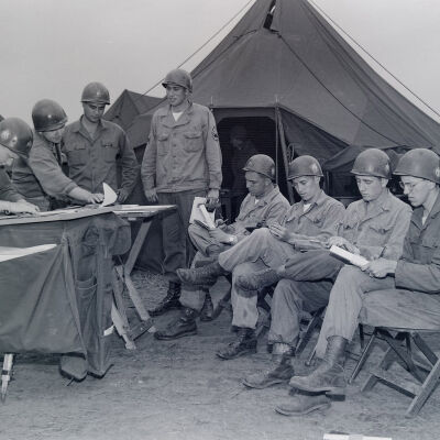 Soldiers reading maps and getting instructions