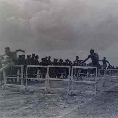Soldiers running high hurdles