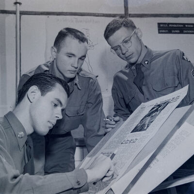 Soldiers with a newspaper layout board