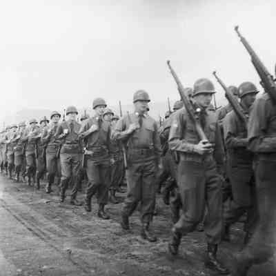 Soldiers marching with shouldered rifles