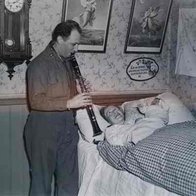 Soldier plays clarinet for mother and baby