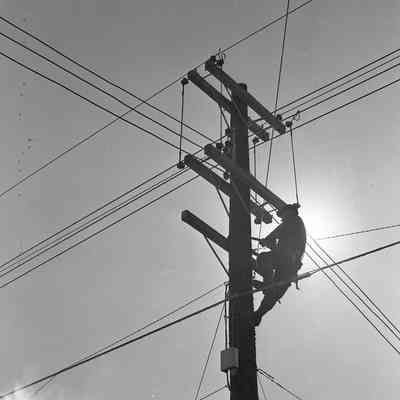 Lineman climbing a power pole