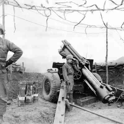 Soldiers firing artillery