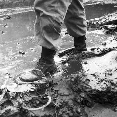 Soldier walking through deep mud