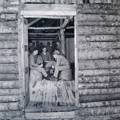 Soldiers drinking beer in a wood building