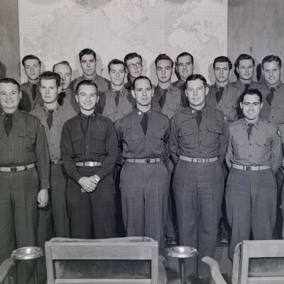 Group shot of soldiers in front of map