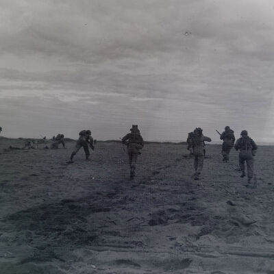 Soldiers advancing across a field
