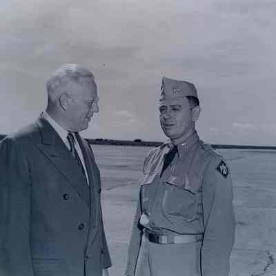 Govenor Earl Warren visiting with a soldier