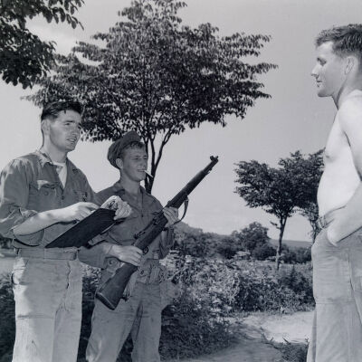 Two soldiers interrogating a mock prisoner