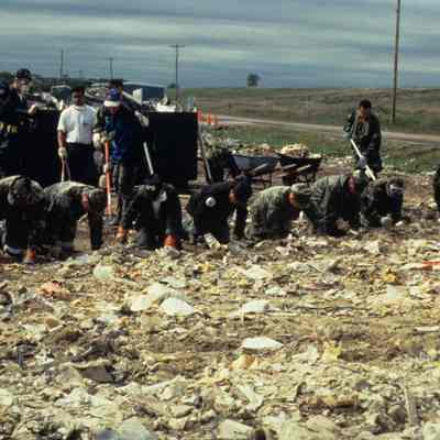 Soldiers searching through rubble