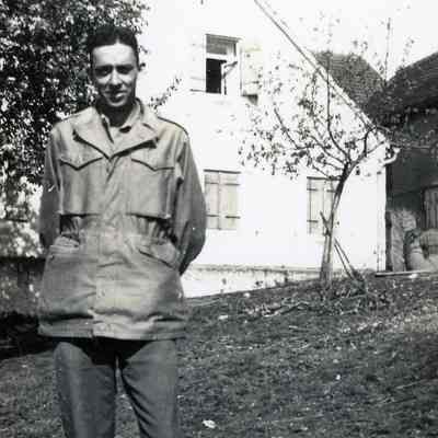 Soldier standing in front of a house