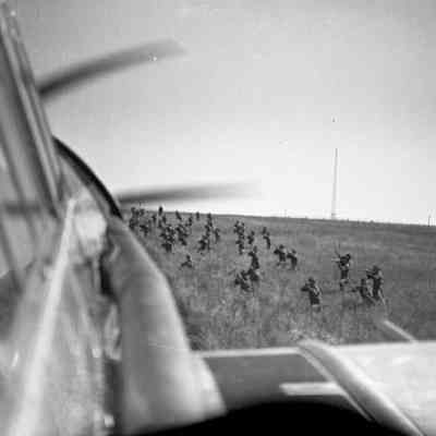 Soldiers aiming their rifles at airplane