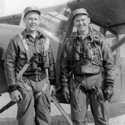 Soldiers pose in front of Plane