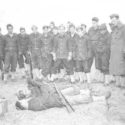 Soldiers learning how to crawl under barbed wire