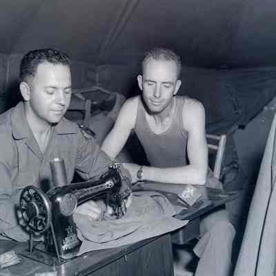 Soldiers using sewing machine