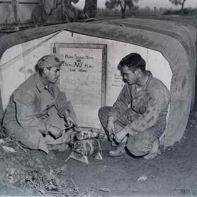 Soldiers sitting outside their makeshift shelter, in the Vicinity of Venafro