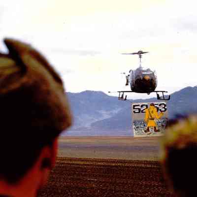 Helicopter holding sign commemorating the time the 45th Division served in Korea