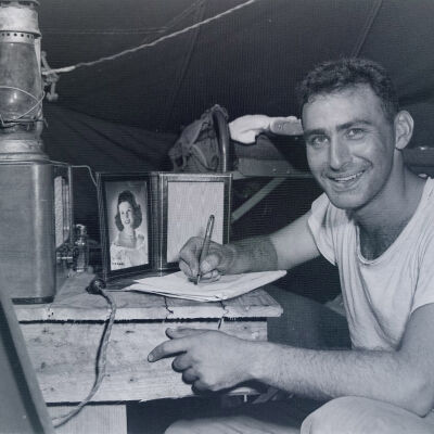 Soldier writing a letter in his tent