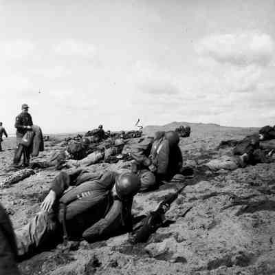 Soldiers taking cover on beach during landing