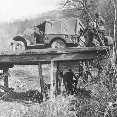 Soldiers securing a wooden bridge