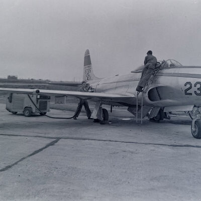 Ground crew servicing an Air Force F-80 jet fighter