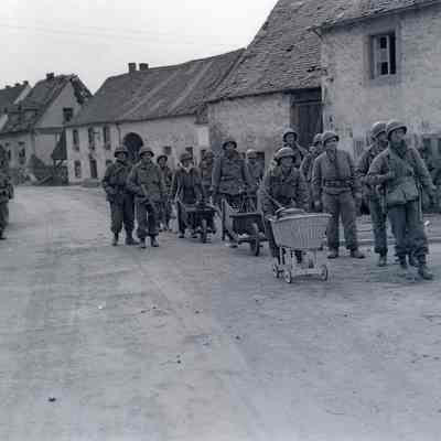 Soldiers using baby carriages and wheelbarrows to transport mortars and ammunition