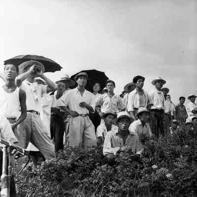 Crowd of Japanese civilians observing an aerial display