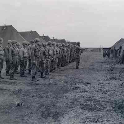 Soldiers standing in formation in camp