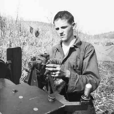 Soldier cleaning artillery piece