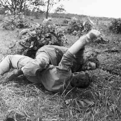 Soldiers wrestling on the ground