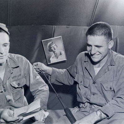 Two soldiers sitting on bunk