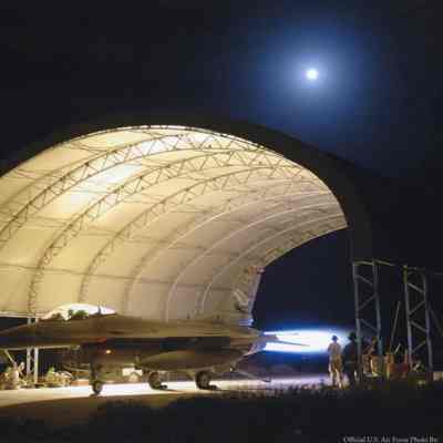 Maintainers working on F-16 engine