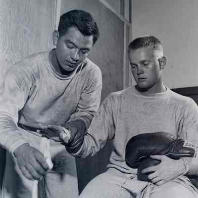 Trainer taping a boxer's hand