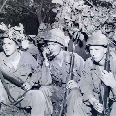 Soldiers with rifles and radio during training