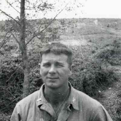 Soldier posed in front of countryside