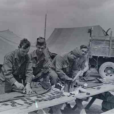 Soldiers painting with stencils