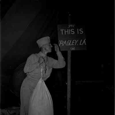 Soldier posed in front of signpost