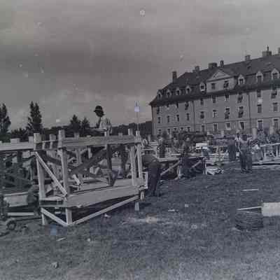Soldiers and German prisoners constructing bunk beds