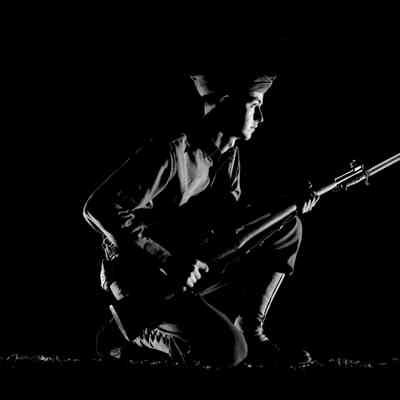 Night shot of soldier with his weapon at the ready