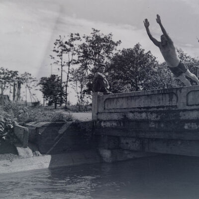 Soldier diving off of a bridge