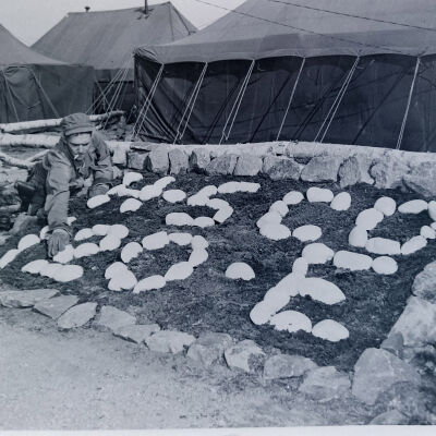 Soldier constructing rock garden sign for 120th Engineer Company