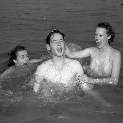 Soldier and two girls playing in the water