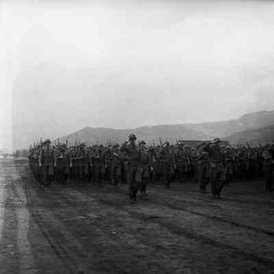 Soldiers marching with shouldered rifles