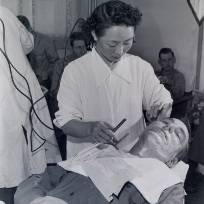 Japanese barber shaving soldier
