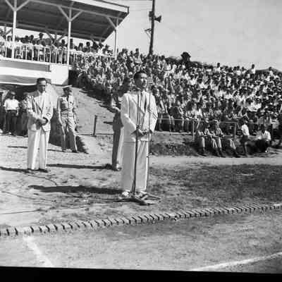 Man at microphone at ceremony for American and Japanese track competition