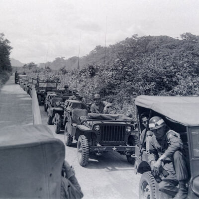 Jeep convoy halted along a road