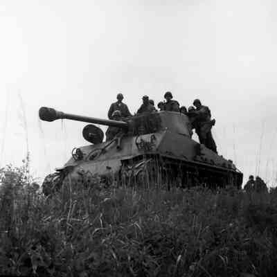 Soldiers riding on a tank